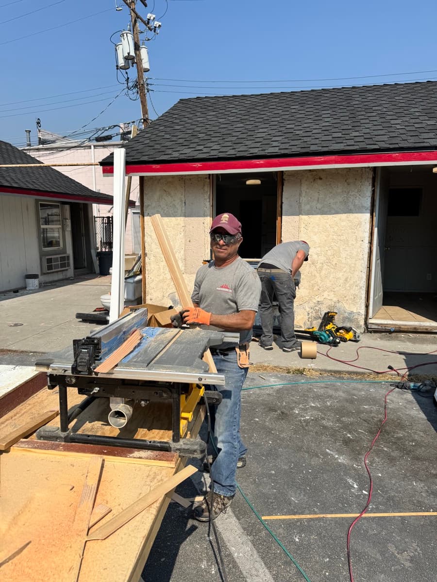 Wood Windows carpenter cutting trim on site